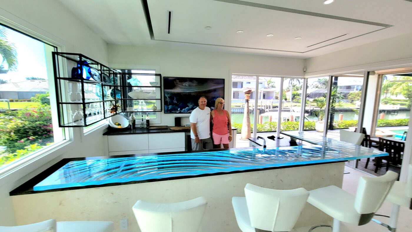L-shaped raised Glass Bar Top in Naples, Florida home with LEDs