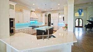 White glass countertop kitchen with custom textured glass backsplash