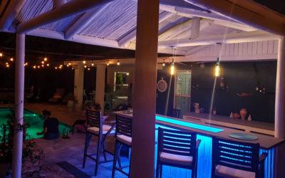Tropical Outdoor Kitchen and Bar with Glass Countertops