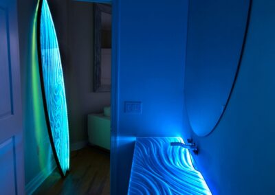 Integrated Countertop sink with LEDs in a floating support with Custom Glass Surfboard