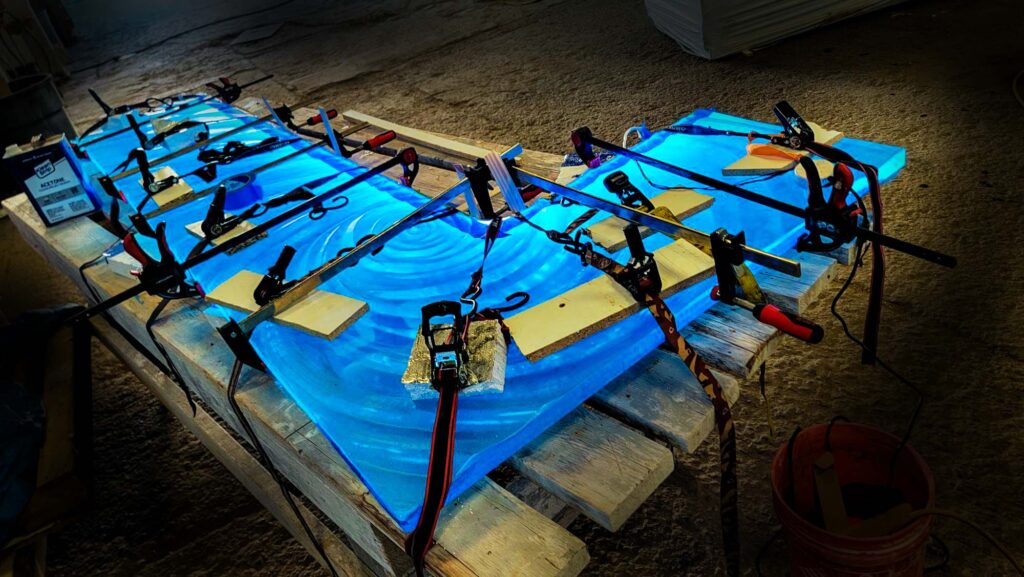 L shaped glass bar top by Downing Designs with LED lights being installed