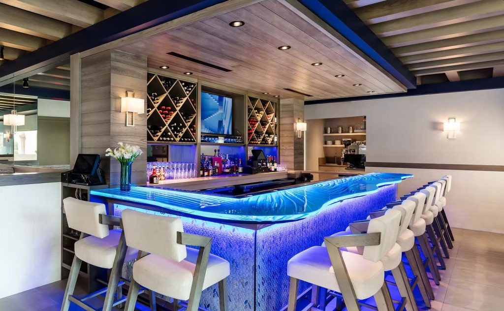 Illuminated custom glass bar tops at Acqua Cafe restaurant in West Palm Beach Florida by Downing Designs