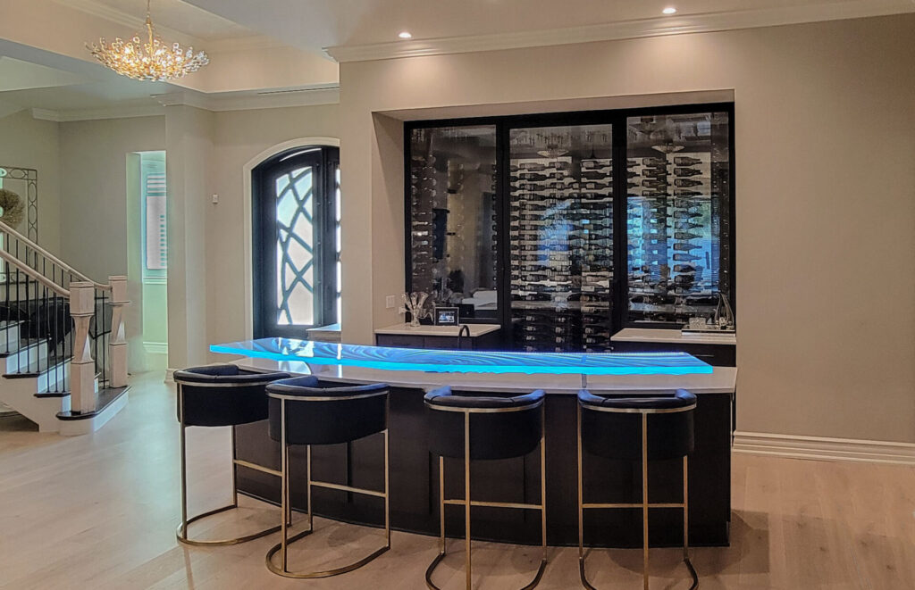 Arced glass bar top Naples Florida luxury home with LED and custom cantilevered aircraft aluminum supports — Downing Designs