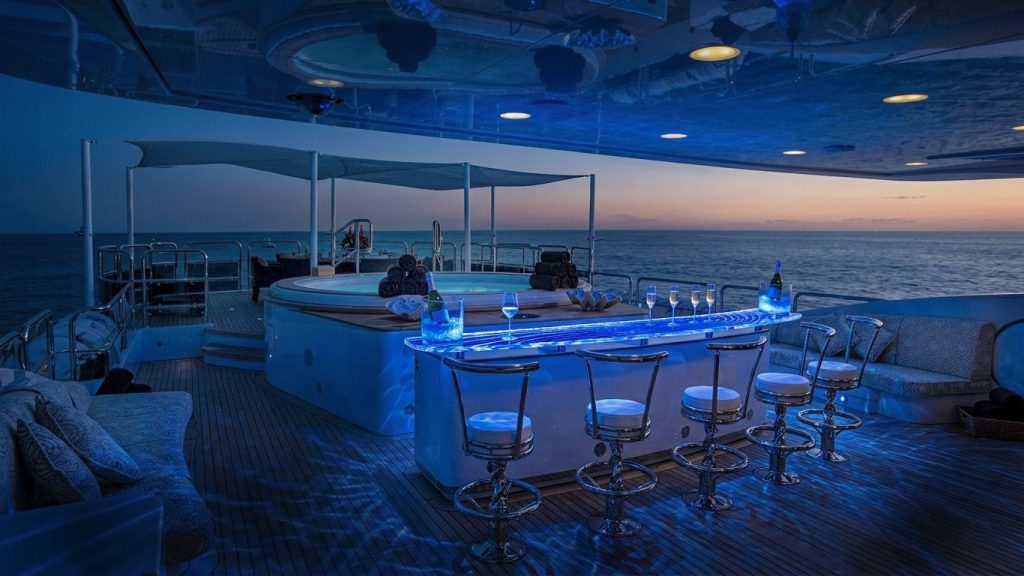 Superyacht deck glass bar top at night with blue LED Superyacht deck glass bar top at night with blue LED