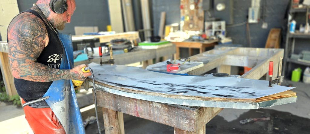 Hand polishing glass counters and bar tops by hand at Downing Designs Tampa