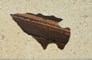 Pre-colonial arrowhead polished flush in concrete bar top surface — Ulele Restaurant Tampa — Downing Designs