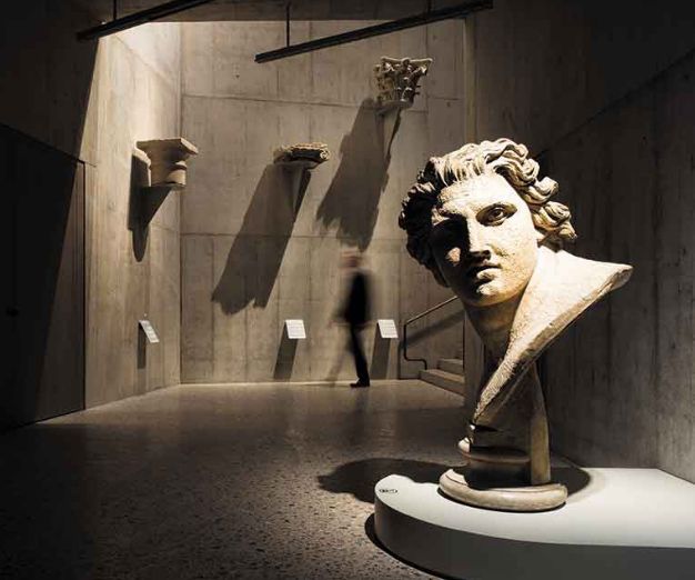 Dramatic downlighting of museum bust