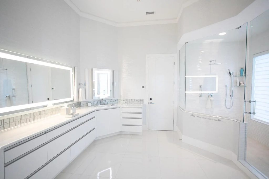 White glass bathroom countertop on a floating vanity in an all white master bath