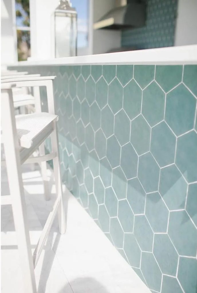 White glass outdoor bar top over teal Art Deco tile