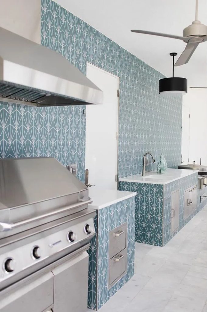 White glass outdoor bar top over teal Art Deco tile on a covered Florida lanai